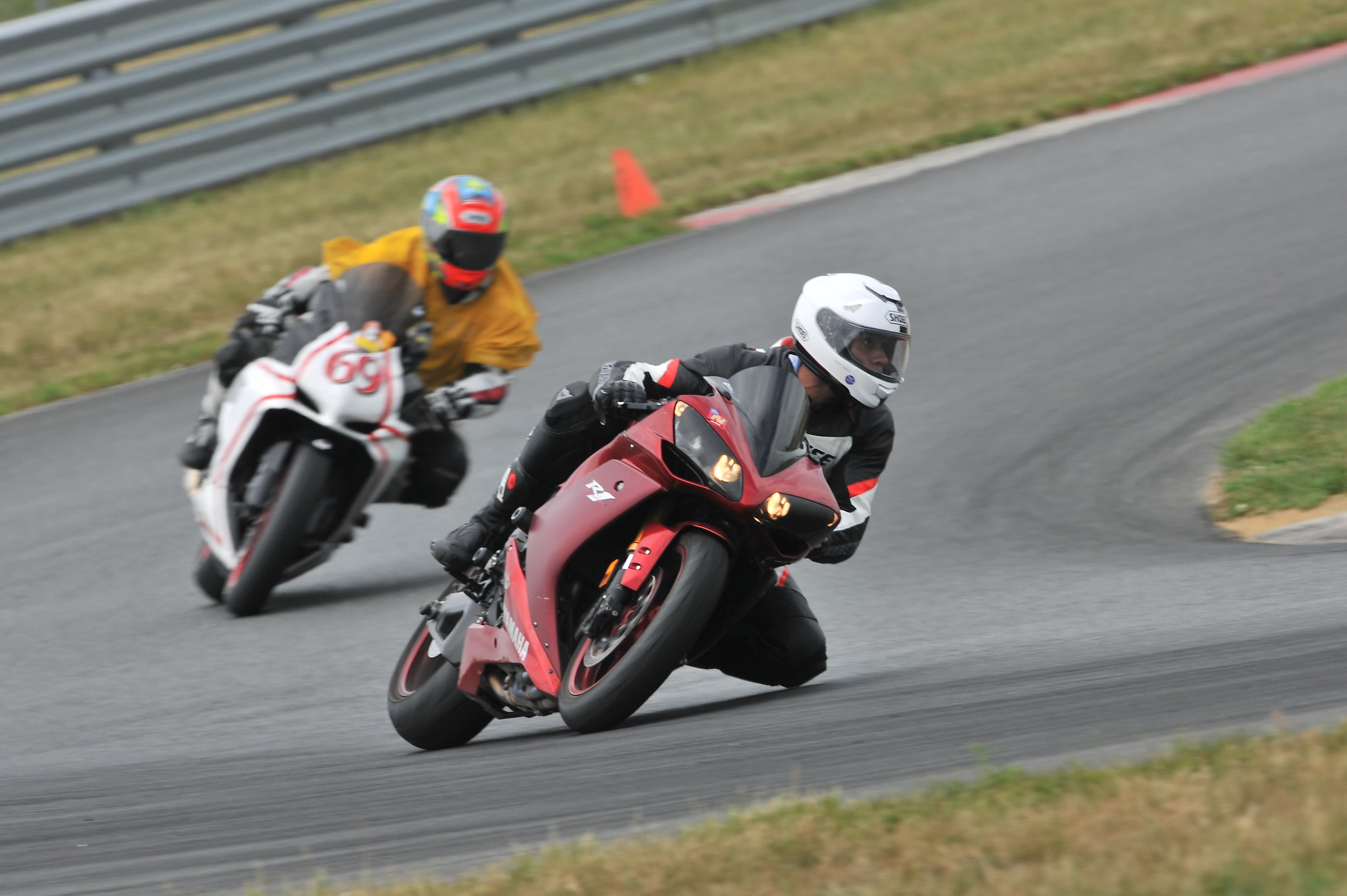 Felix leading on a red Yamaha R1 during a motorcycle track day, a white #69 sportbike behind